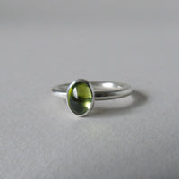 silver ring with oval peridot