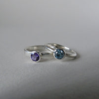 silver ring with faceted amethyst or blue zircon