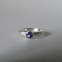 silver ring with faceted amethyst or blue zircon