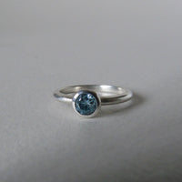 silver ring with faceted amethyst or blue zircon