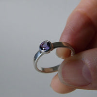 silver ring with faceted amethyst or blue zircon