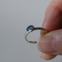 silver ring with faceted amethyst or blue zircon