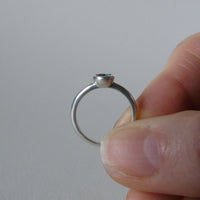 silver ring with faceted amethyst or blue zircon