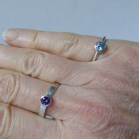 silver ring with faceted amethyst or blue zircon