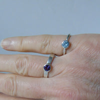 silver ring with faceted amethyst or blue zircon