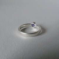 silver ring with faceted amethyst or blue zircon