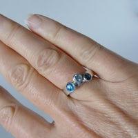 silver ring with three blue topaz