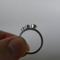 silver ring with three blue topaz