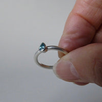 silver ring with pear blue zircon
