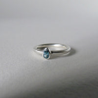 silver ring with pear blue zircon