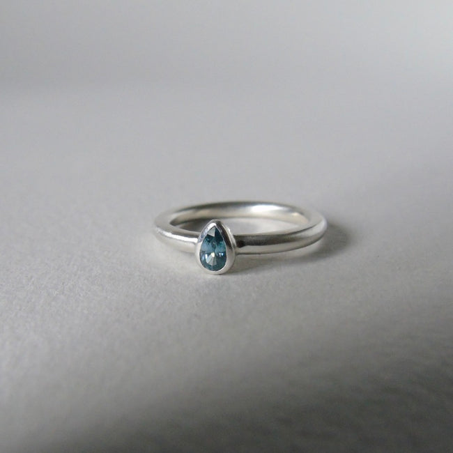 silver ring with pear blue zircon