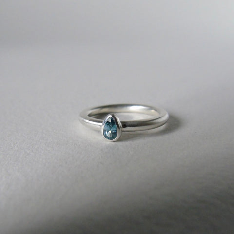 silver ring with pear blue zircon