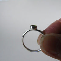 silver ring with round peridot