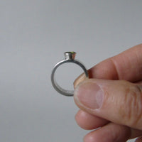 silver ring with faceted peridot or blue topaz