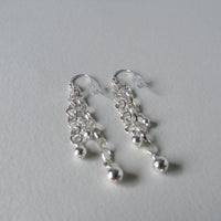 Long drop silver bead earrings