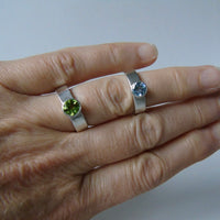 silver ring with faceted peridot or blue topaz