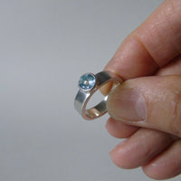 silver ring with faceted peridot or blue topaz