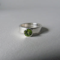 silver ring with faceted peridot or blue topaz
