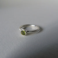 silver ring with round peridot