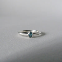 silver ring with pear blue zircon