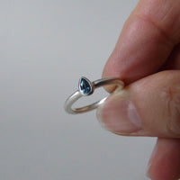 silver ring with pear blue zircon