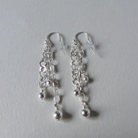 Long drop silver bead earrings