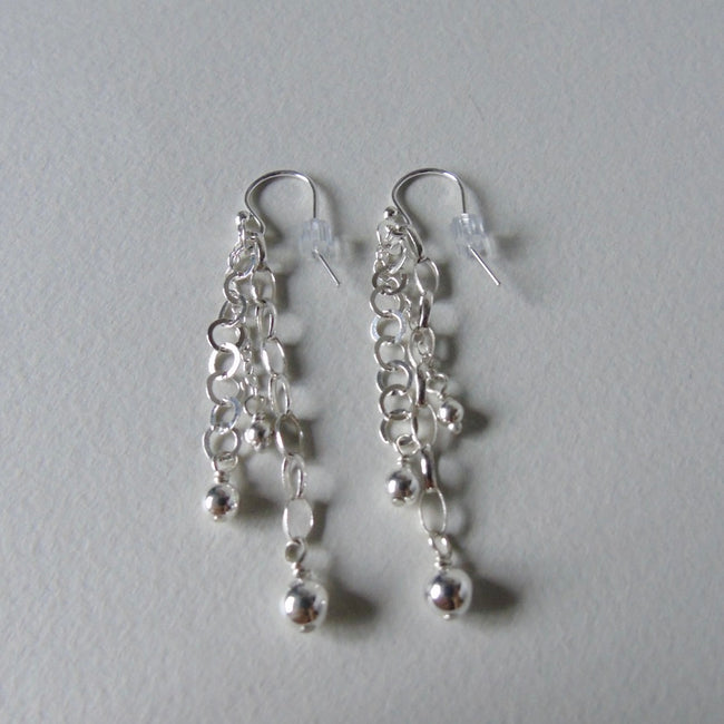 Long drop silver bead earrings