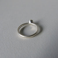 silver ring with round peridot