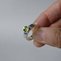 silver ring with faceted peridot or blue topaz