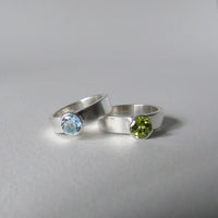 silver ring with faceted peridot or blue topaz