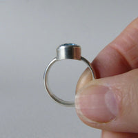 silver ring with oval salt and pepper aquamarine