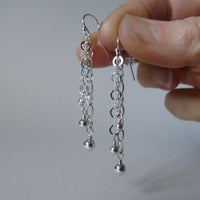 Long drop silver bead earrings