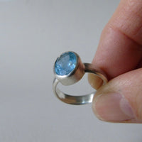 silver ring with oval salt and pepper aquamarine