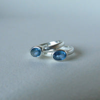 silver ring with faceted blue sapphire