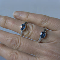 silver ring with faceted blue sapphire