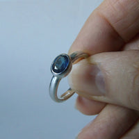 silver ring with faceted blue sapphire