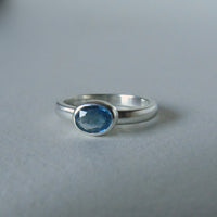 silver ring with faceted blue sapphire