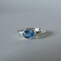 silver ring with faceted blue sapphire