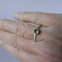 silver ring with round peridot