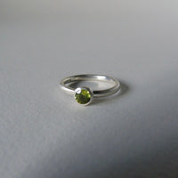 silver ring with round peridot