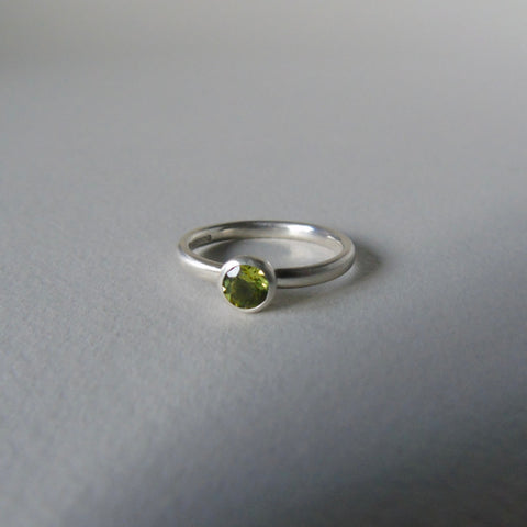 silver ring with round peridot