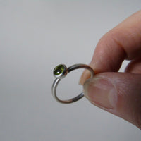 silver ring with round peridot