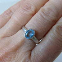 silver ring with oval cloudy blue aquamarine